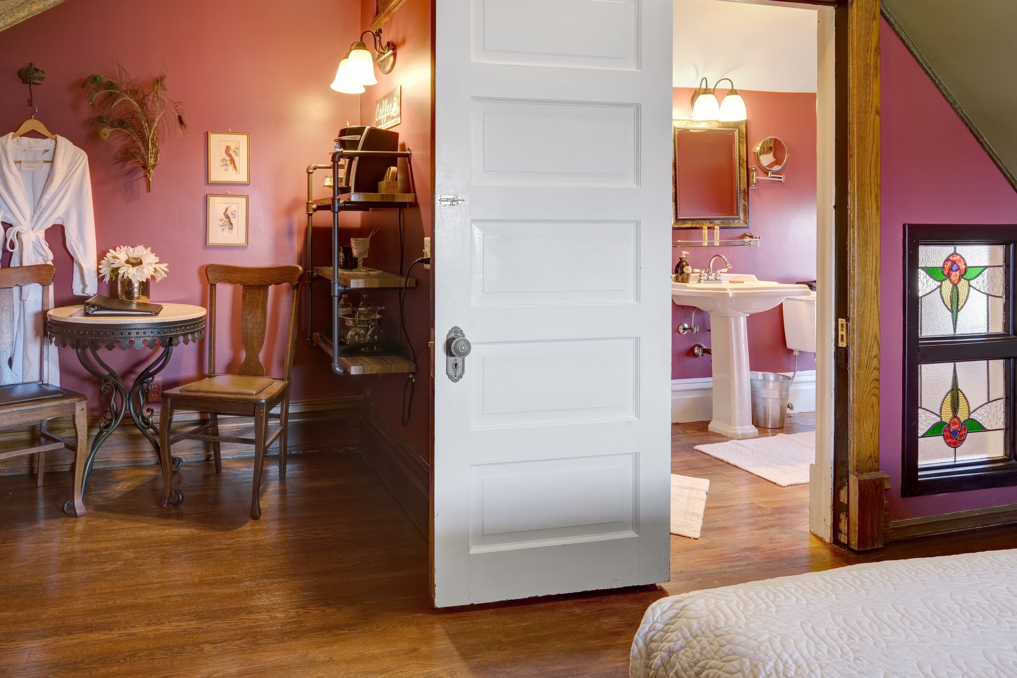 Room with table/chairs, queen bed and ensuite bath