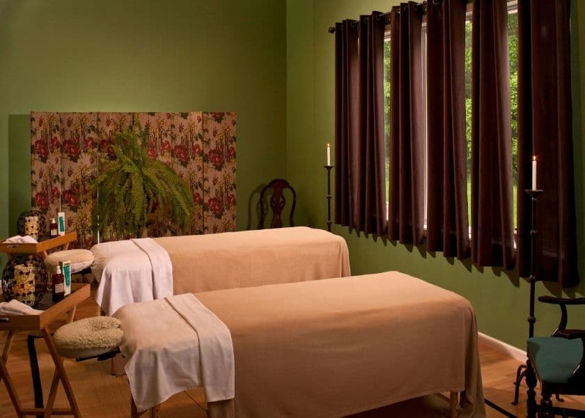 Side-by-side massage tables set up for a couples spa getaway in the Spa Room at Castle in the Country.