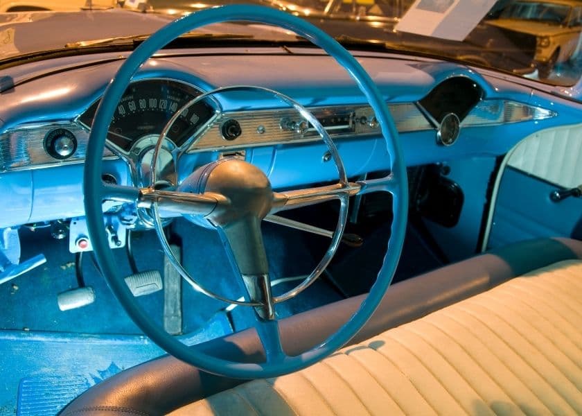 dashboard steering wheel and front seat interior of an antique american car dashboard steering wheel and front seat interior of an antique american car