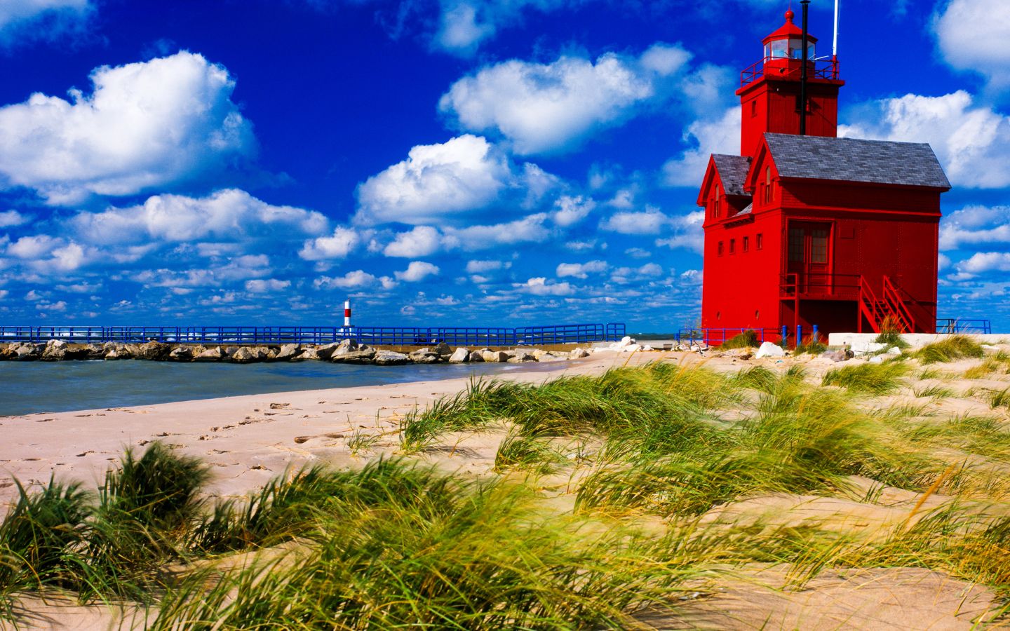 the shoreline south of holland michigan’s big red lighthouse on a sunny summer day