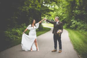 Bride and groom on the winding driveway in the summer