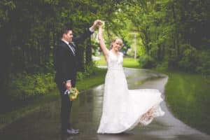Wedding couple on the driveway in summer after the rain