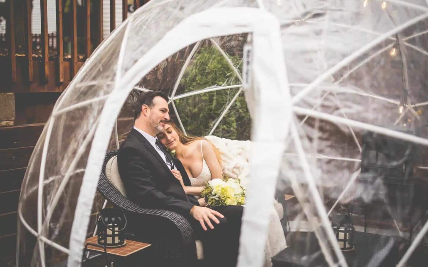 wedding couple cuddle in the igloo in the garden at castle in the country